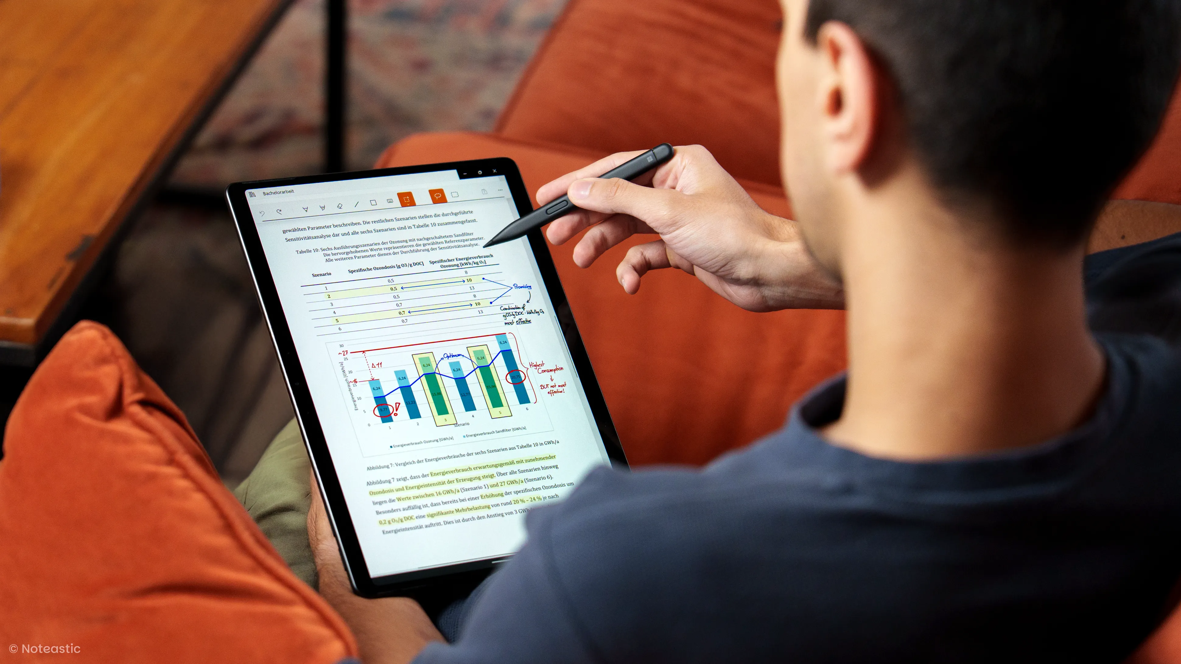 A person working on a Windows tablet making handwritten notes on a PDF